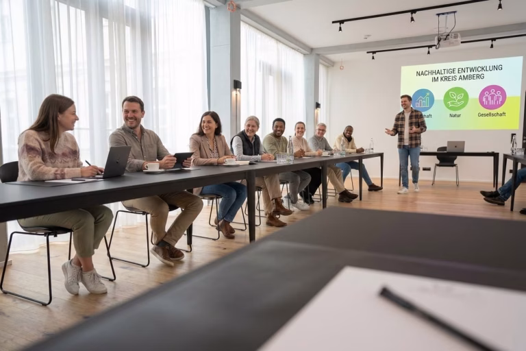Ein Tagungsraum in Amberg voller leute, die gerade ein Meeting abhalten.
